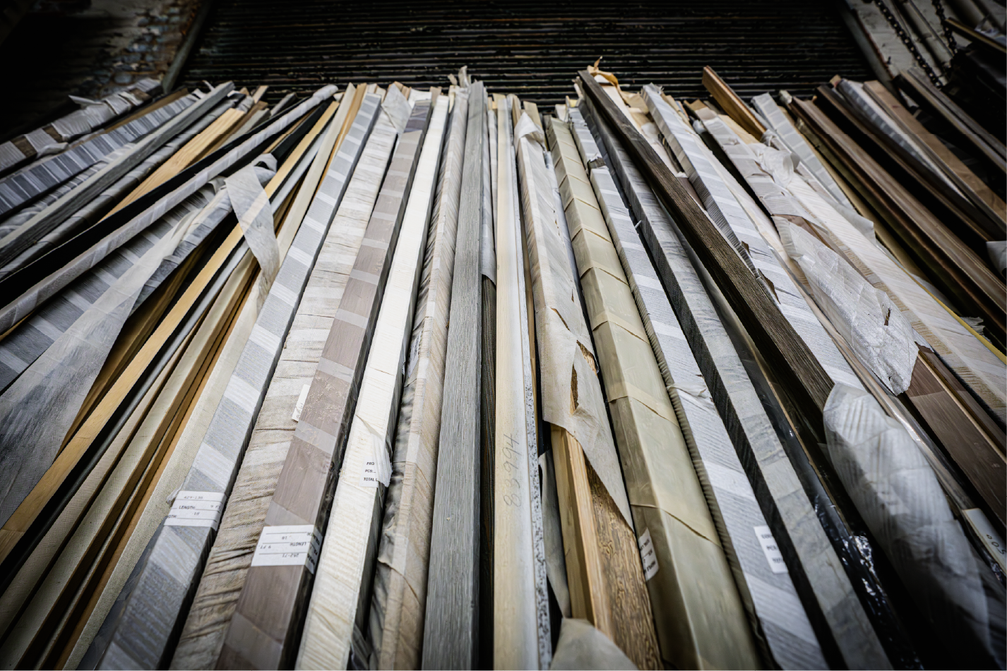 Stacked wooden frame moldings wrapped and organized in workshop